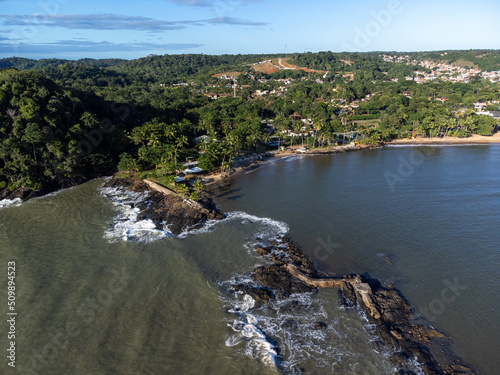 Aerial drone view of rocks separating the sea from the river in a coastal city