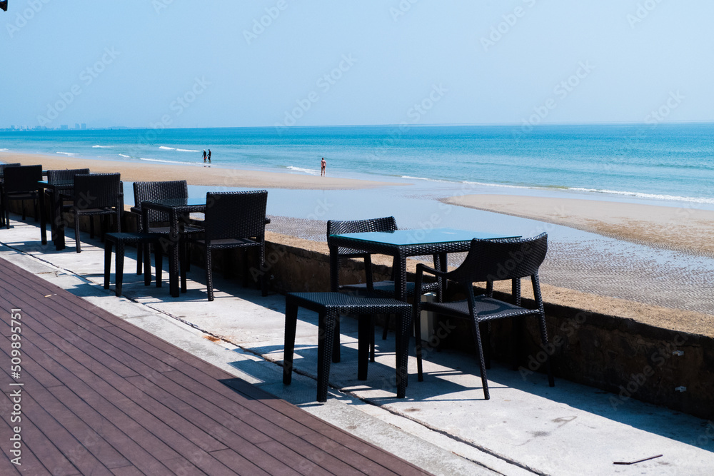 Empty Chair and table with sea on the beach.