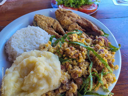Rice with fried fish and tropeiro beans - typical Brazilian dish photo