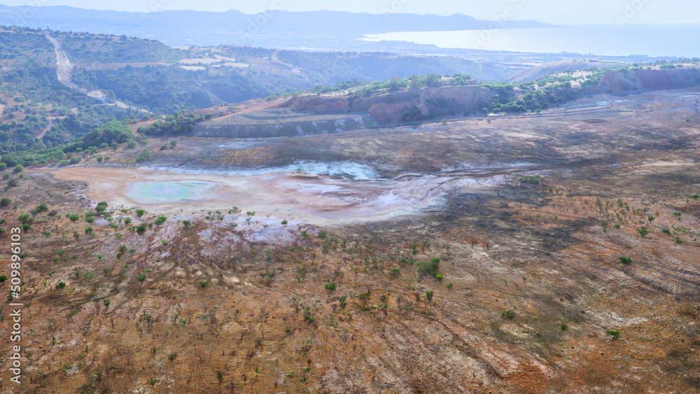 Abandoned site of Limni copper mine, Cyprus aerial landscape. Backfilled open pit with dried pool and colorful spots of chemicals Abandoned site of Limni copper mine, Cyprus aerial landscape. Backfilled open pit with dried pool and colorful spots of chemicals