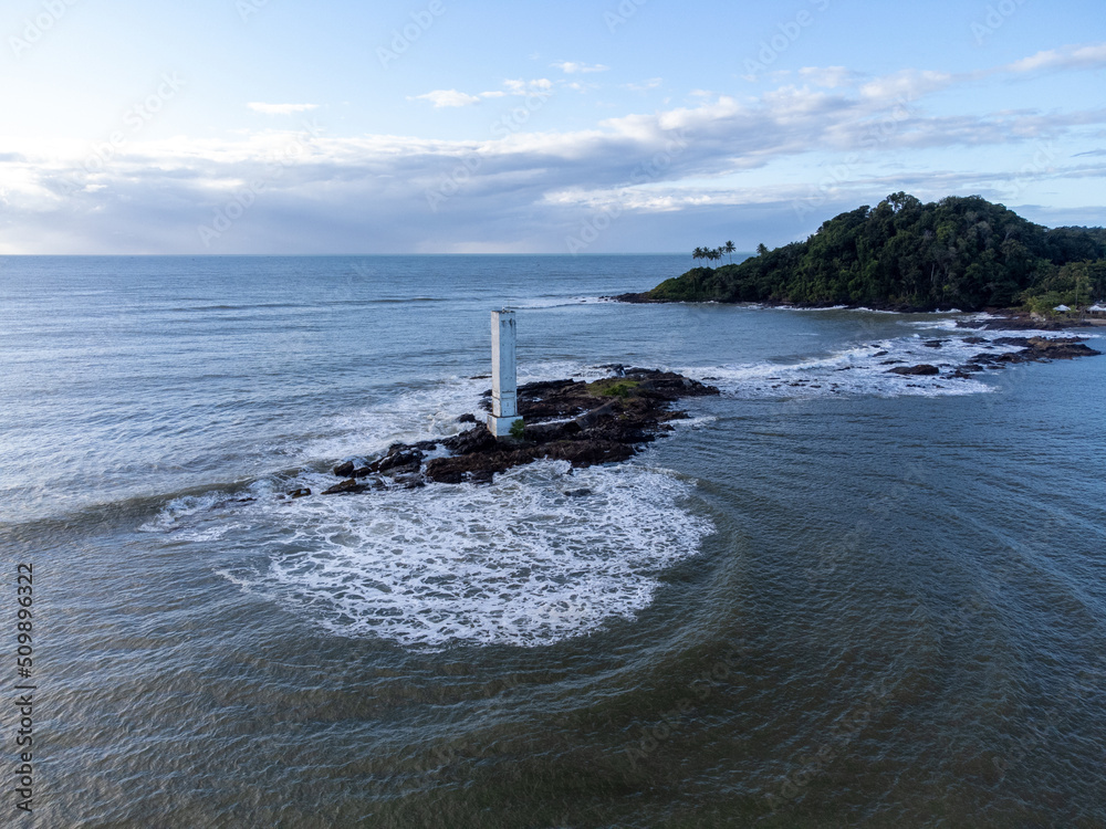 Maritime lighthouse on beautiful beach crossing with river - Itacaré, Bahia, Brazil