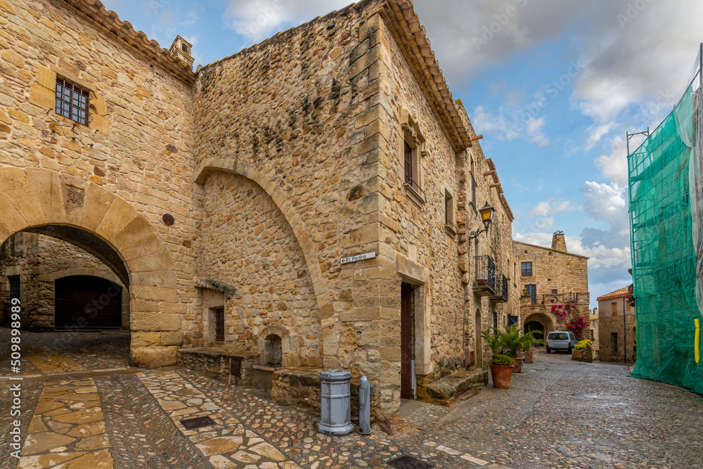 An arched tunneled entrance into the medieval village of Pals, Spain, in the Girona Province of the Costa Brava coast.