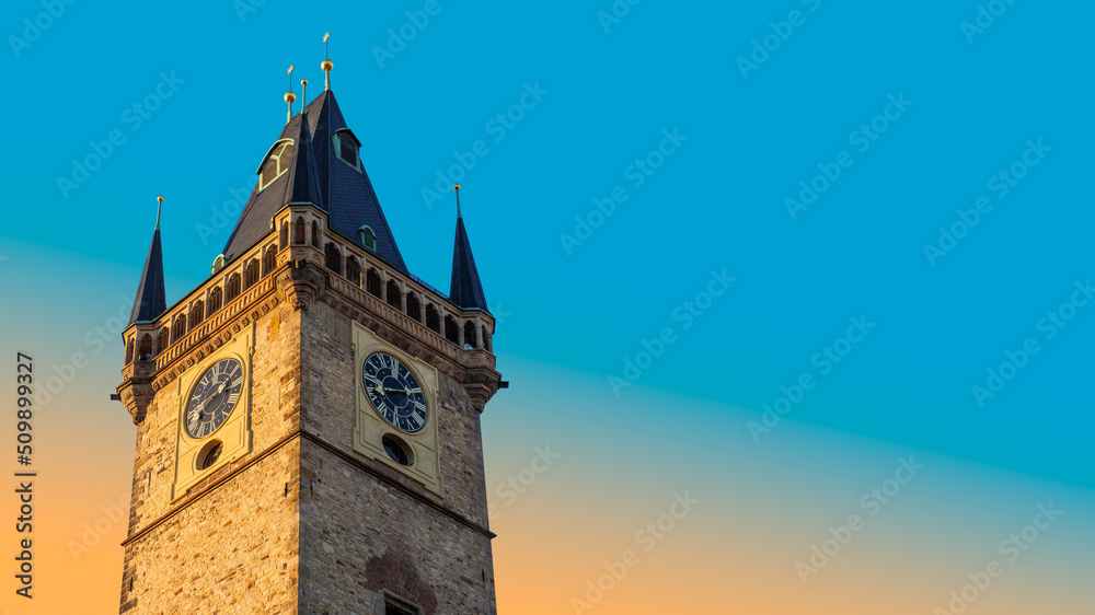 Old Town Hall on sunset with ancient clock on tower in historic downtown of Prague, Czechia. Medieval landmarks and architecture of Europe for travel agency banner with place for text on blue sky.
