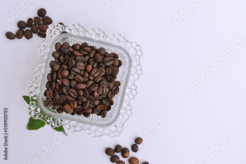 Close up of a glass plate filled with coffee beans