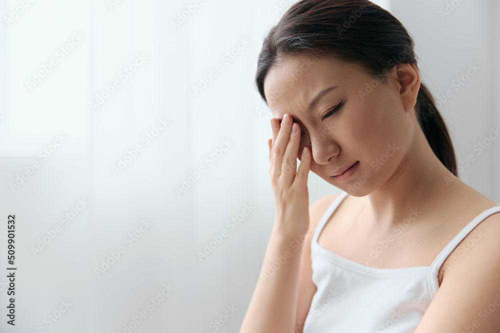 Suffering From Strong Eye Pain. Eyesight problem. Tormented suffering tanned beautiful young Asian woman touching eyes at home interior living room. Injuries Poor health Illness concept. Cool offer Suffering From Strong Eye Pain. Eyesight problem. Tormented suffering tanned beautiful young Asian woman touching eyes at home interior living room. Injuries Poor health Illness concept. Cool offer