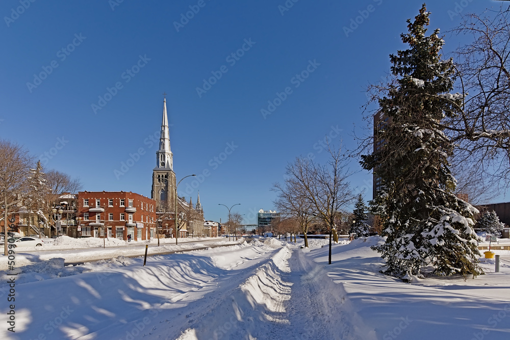 Church of St. Peter the Apostle and Boulevard Rene-Levesque in the snow