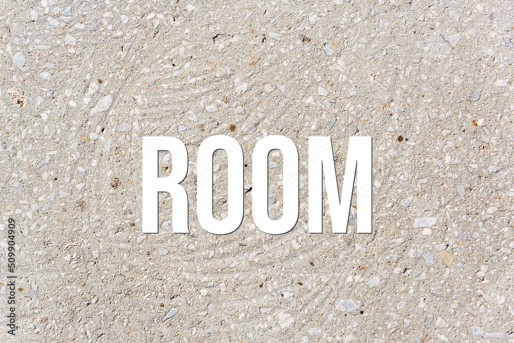 ROOM - word on concrete background. Cement floor, wall. ROOM - word on concrete background. Cement floor, wall.