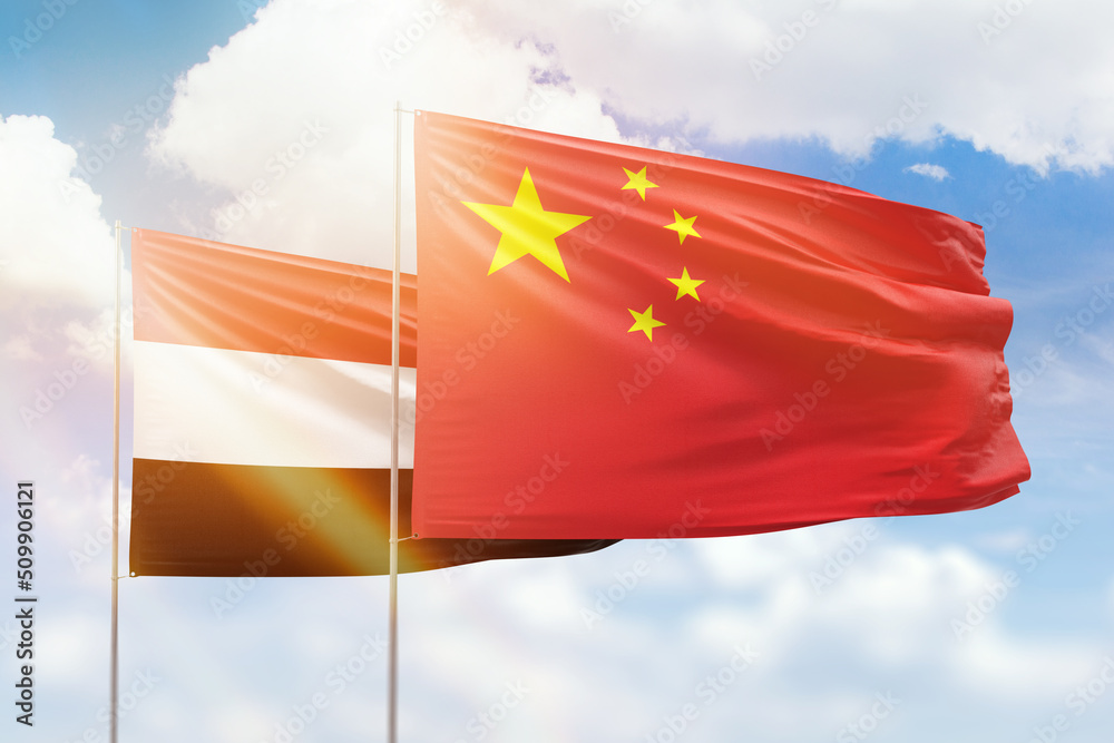Sunny blue sky and flags of china and yemen Sunny blue sky and flags of china and yemen