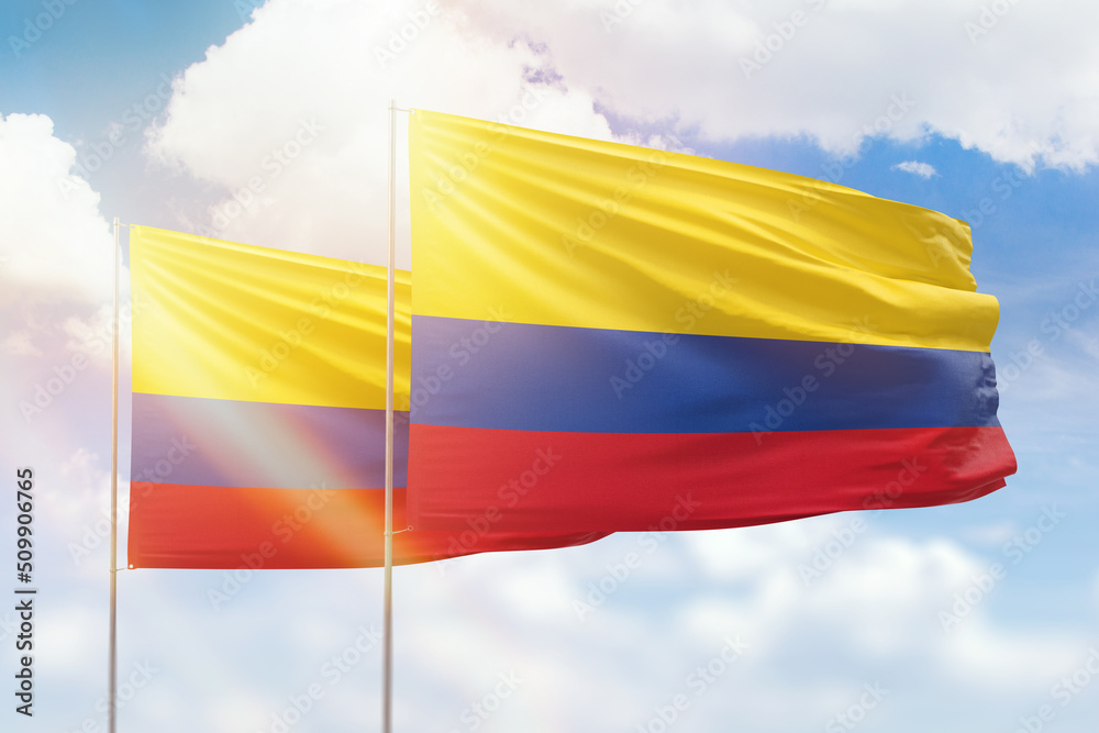 Sunny blue sky and flags of colombia and colombia Sunny blue sky and flags of colombia and colombia