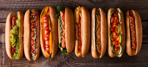 Photography Many tasty hot dogs on wooden background, top view