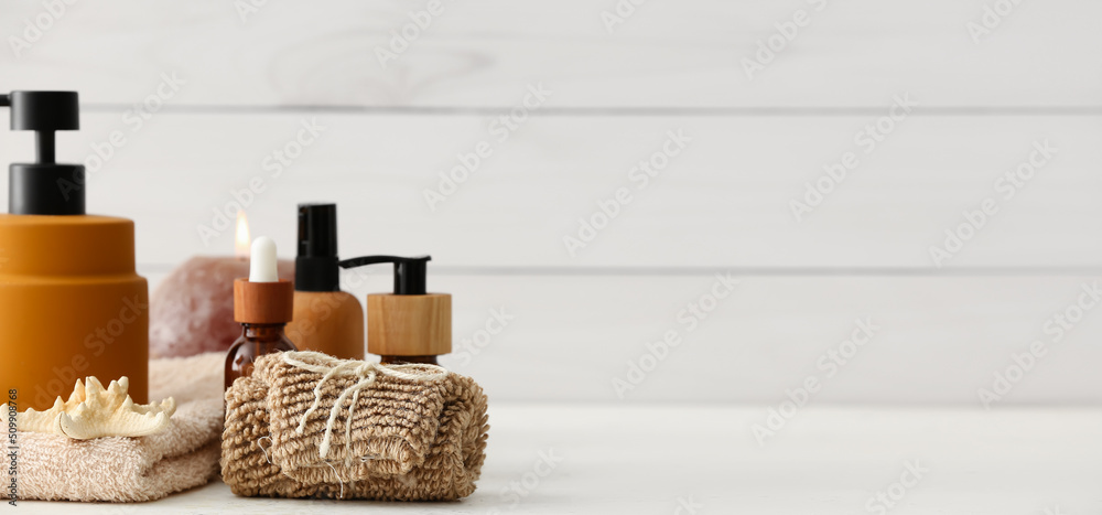 Natural cosmetic products with bathing supplies on light background with space for text