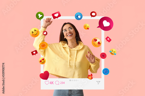 Happy young female blogger on pink background photo