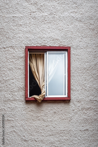 Obraz na płótnie Small Open Window with a Red Frame and a Yellow Curtain on the Inside w salonie
