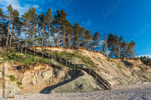 Steep shore of the Baltic Sea and wooden stairs, Labrags, Latvia. photo