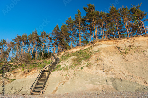 Steep shore of the Baltic Sea and wooden stairs, Labrags, Latvia. photo