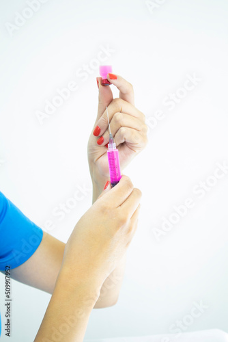 Professional laboratory technician preparing injection on white background