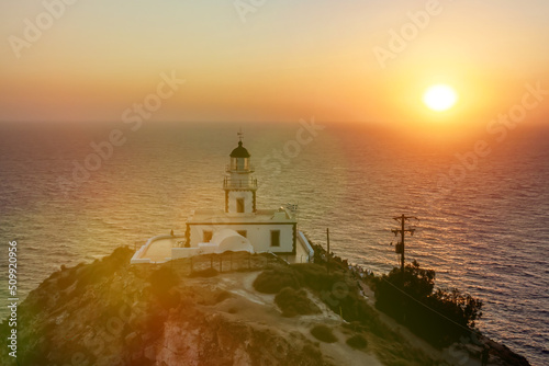 Seashore lighthouse, beacon during sunset. © 9parusnikov