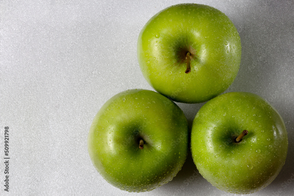 Green apples. Top view, white surface. Green apples. Top view, white surface.