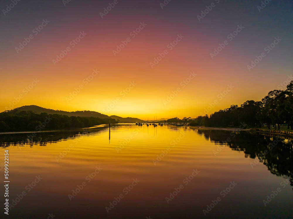 Orange and pink glow with clear skies, sunrise waterscape at the Channel