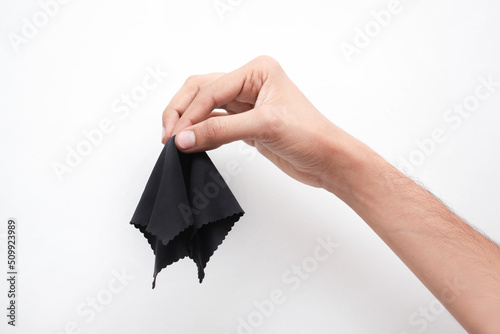 Stampa su tela Mano agarrando un pañuelo negro en un fondo aislado blanco
