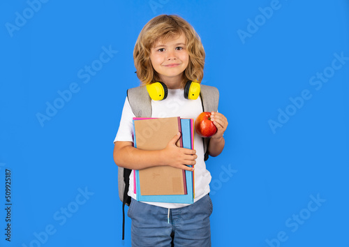 Schoolchild in school uniform with backpack. Teen student on isolated background. Portrait of happy smiling school kid. Positive emotions.