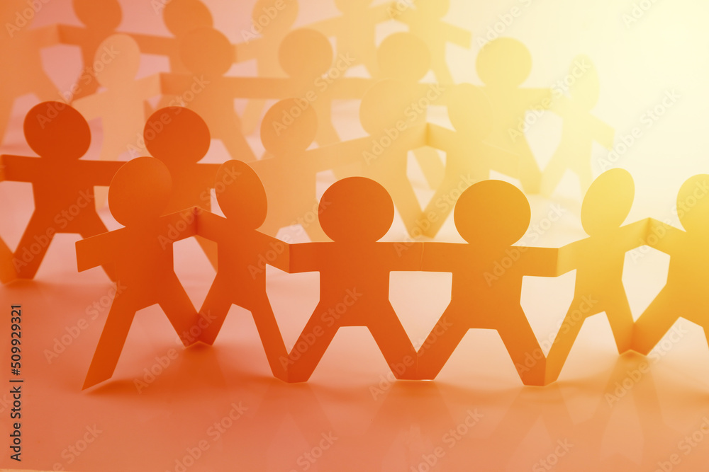Group of paper chain people united together Group of paper chain people united together