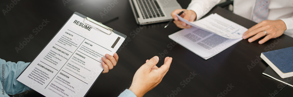 Recruitment concept, Male employer read resume while applicants explaining CVs and work experiences Recruitment concept, Male employer read resume while applicants explaining CVs and work experiences
