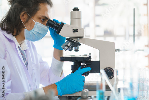 Laboratory research concept, Scientist working in lab with microscope to research drug and vaccine
