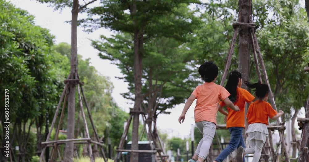 4K video slow motion Asian children wear orange t-shirt play in playground. Concept for funny and active activity of kid. 4K video slow motion Asian children wear orange t-shirt play in playground. Concept for funny and active activity of kid.