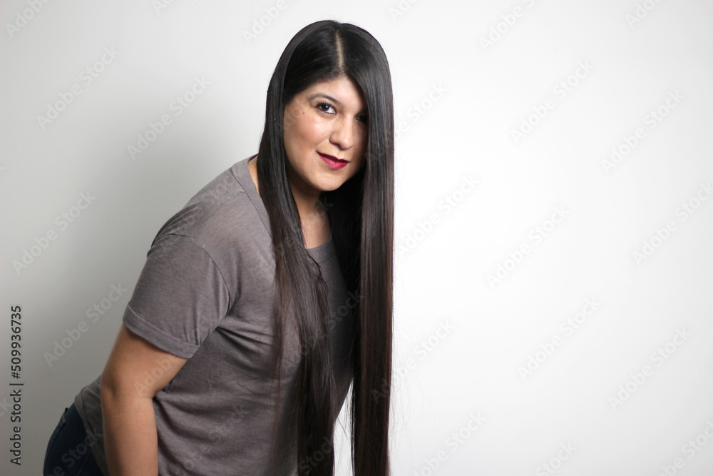 Latin young adult woman shows how silky and shiny her black hair is, very long, straight, very happy and proud of the beautiful hair with a beautiful haircut Latin young adult woman shows how silky and shiny her black hair is, very long, straight, very happy and proud of the beautiful hair with a beautiful haircut