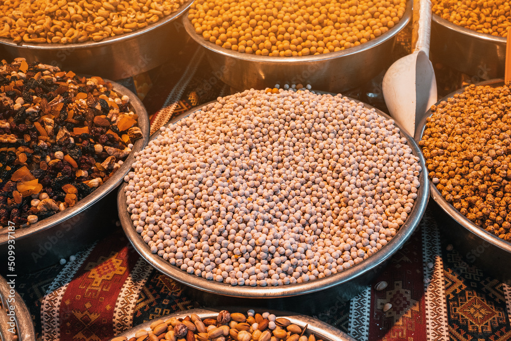 Roasted chickpeas, dried fruits and other nuts on the farmers counter at the local market or oriental bazaar Roasted chickpeas, dried fruits and other nuts on the farmers counter at the local market or oriental bazaar