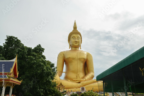Golden big Buddha statue at Wat Muang located in Ang Thong province, Thailand. People come to pray respect to the large golden Buddha statue.