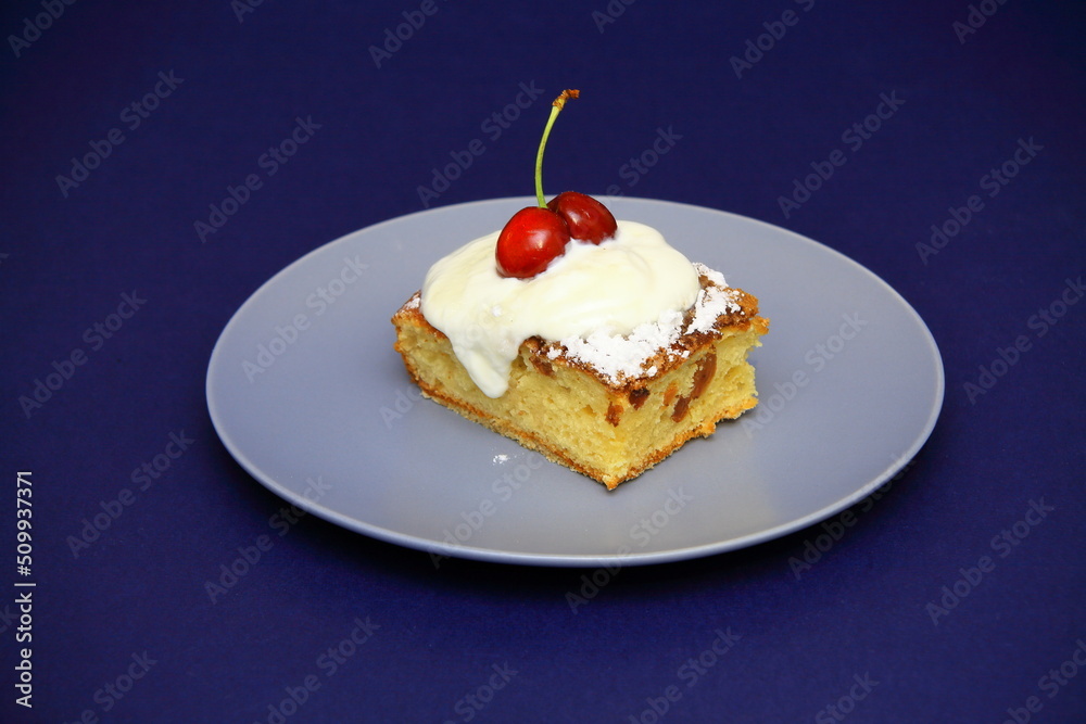 Tasty cake with white fondant and red cherry. on the plate. Confectionery, cake. food. sweet concept. Tasty cake with white fondant and red cherry. on the plate. Confectionery, cake. food. sweet concept.