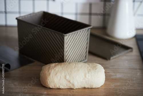 The process of making homemade toast bread in a mold. The concept of healthy homemade food. Front view.