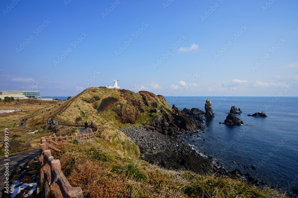 lighthouse and seaside walkway