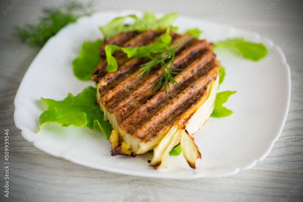 piece of grilled baked cabbage with spices in a plate piece of grilled baked cabbage with spices in a plate
