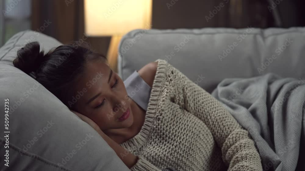 Frustrated and depressed young Asian woman is crying with a smartphone in hand while she lying in the couch at home, sad Asian female on sofa feel down read bad news on cellphone online. Frustrated and depressed young Asian woman is crying with a smartphone in hand while she lying in the couch at home, sad Asian female on sofa feel down read bad news on cellphone online.