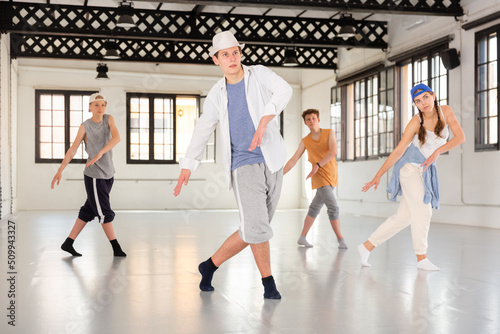 Group of teenagers dancing shuffle and swing dances photo