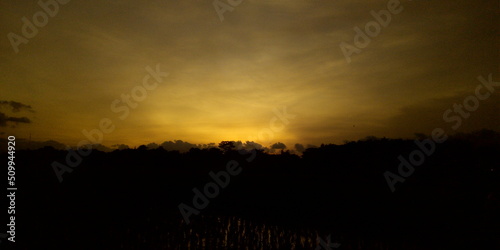 golden yellow sky at sunset in a countryside