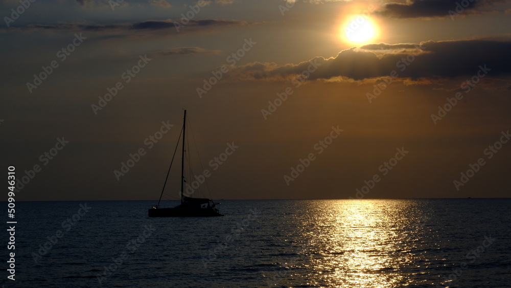 Yacht in the sea at sunset, sailing boat at sunset.