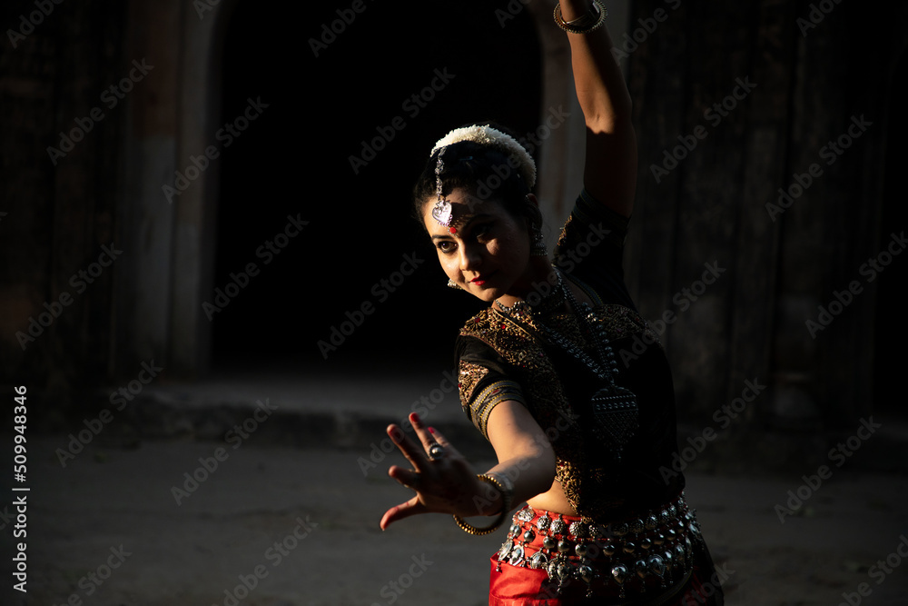 Naklejka premium Indian woman Odissi dancer doing classical dance form. Orissi dance. art and culture of india.