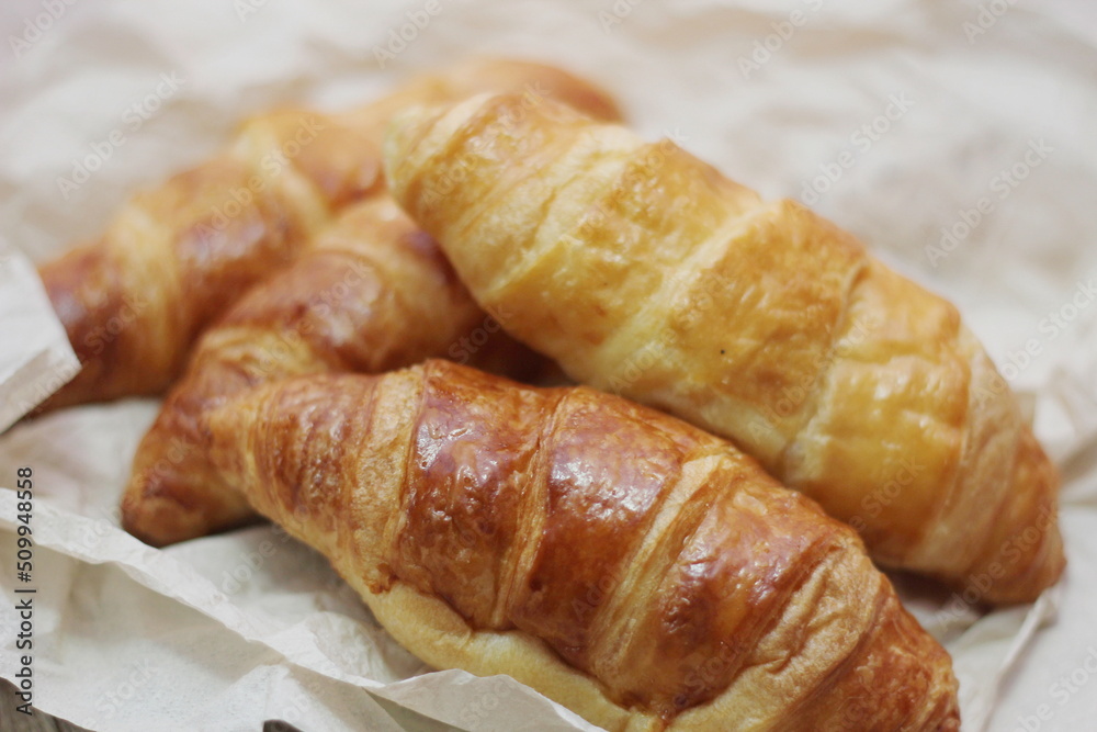 Delicious fresh croissants arranged on a plate Delicious fresh croissants arranged on a plate