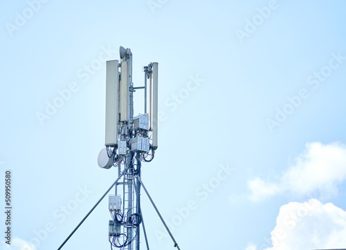 Telecommunication tower with wireless communication antenna transmitter against blue sky. Internet, 3G, 4G and 5G cellular connection.