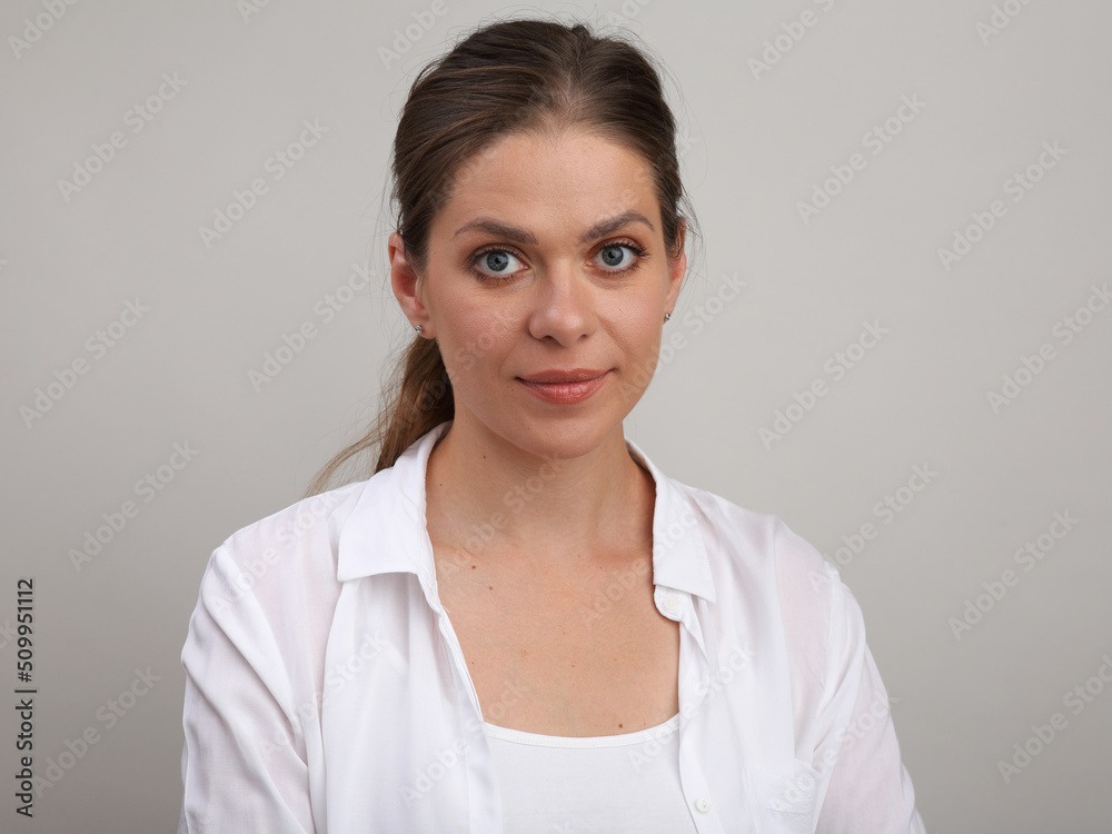 Smiling woman wearing white shirt. Isolated portrait. Smiling woman wearing white shirt. Isolated portrait.
