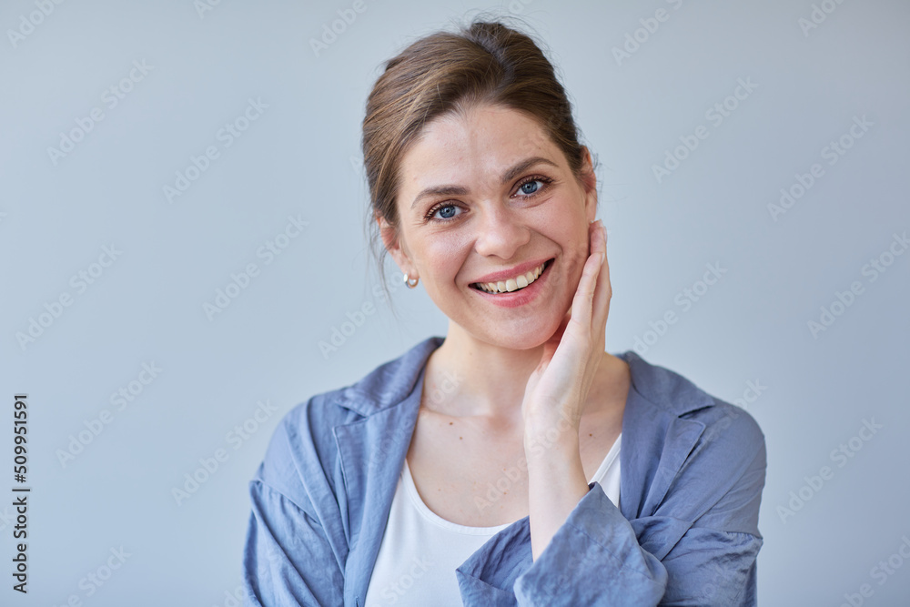 Smiling woman touching her face close up portrait. Girl in blue pajamas. Smiling woman touching her face close up portrait. Girl in blue pajamas.
