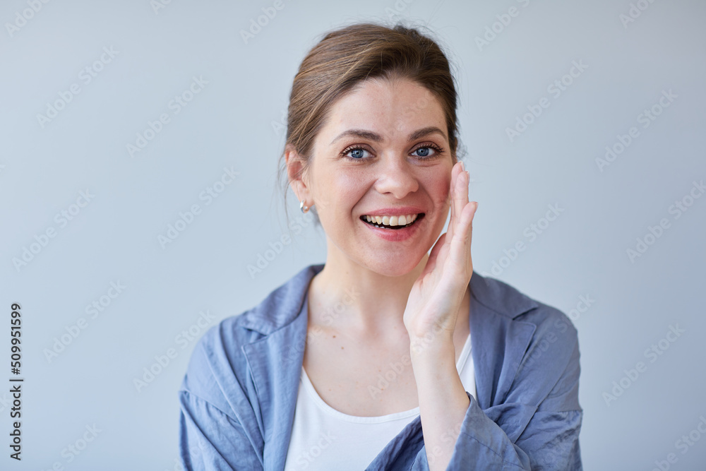 Smiling woman touching her face close up portrait. Girl in blue pajamas. Smiling woman touching her face close up portrait. Girl in blue pajamas.