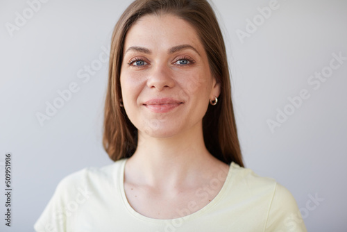 Smiling woman close up face portrait. Girl looking away. Female head shot with shallow depth of field.