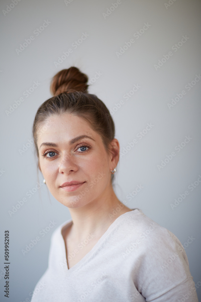 Close up woman face portrait with bunch har dres, haircut. Female head shot with shallow depth of field. Close up woman face portrait with bunch har dres, haircut. Female head shot with shallow depth of field.