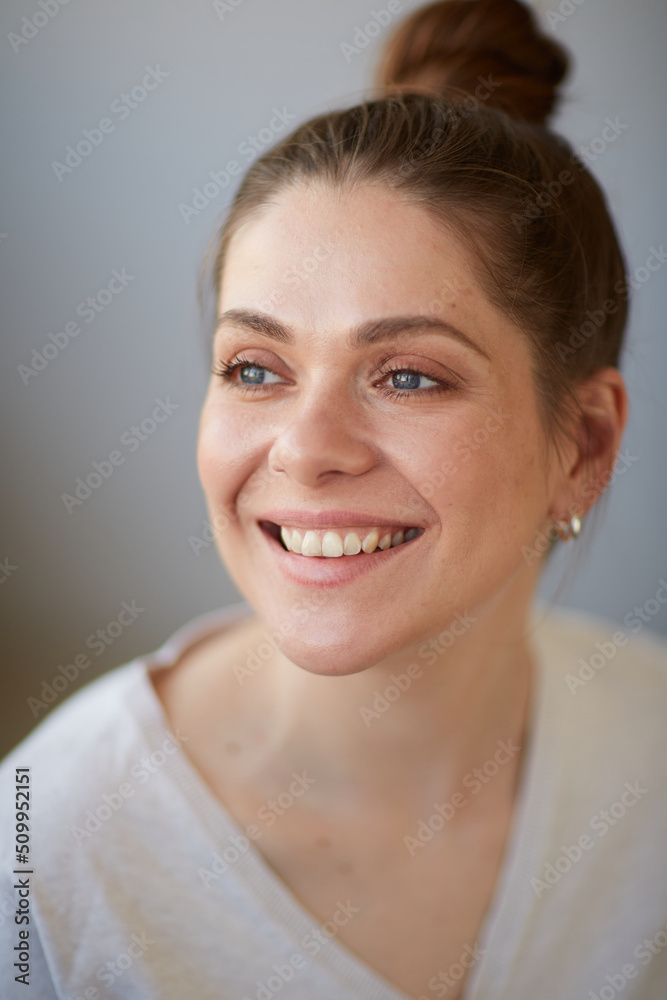 Smiling woman looking away close up face portrait. Female head shot with shallow depth of field. Smiling woman looking away close up face portrait. Female head shot with shallow depth of field.