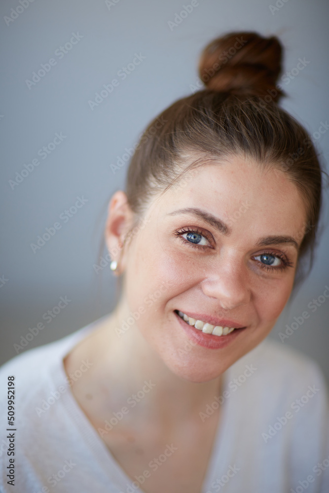 Close up woman face portrait with bunch har dres, haircut. Female head shot with shallow depth of field. Close up woman face portrait with bunch har dres, haircut. Female head shot with shallow depth of field.